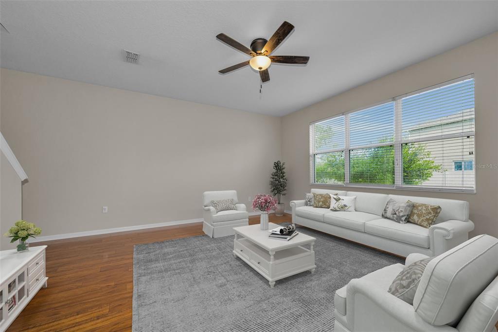 A kitchen with oak cabinets, stainless steel dishwasher, double sink, and light-colored tile flooring — 17539 BALMAHA DRIVE, LAND O LAKES, FL