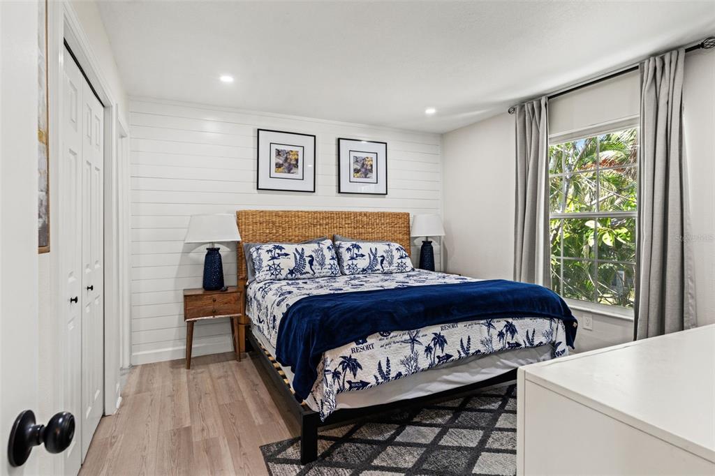 A living room and kitchen area feature a blue sofa, wood coffee table, and shiplap walls — 8106 GULF DRIVE UNIT A&B, HOLMES BEACH, FL