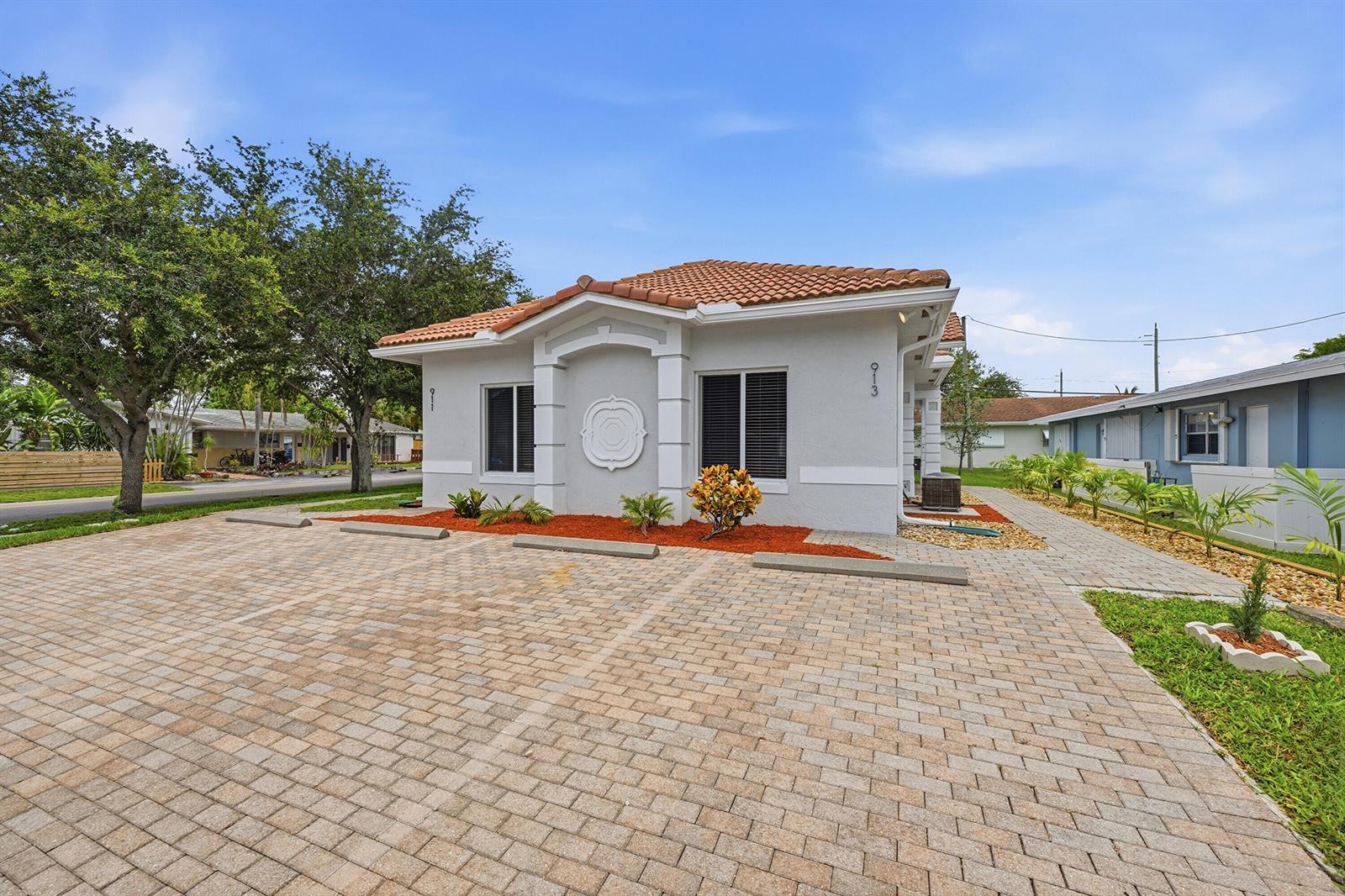 A single-story building with a tiled roof and a paved parking area in front — 911 NE 12th Avenue, Pompano Beach FL 33060, POMPANO BEACH, FL