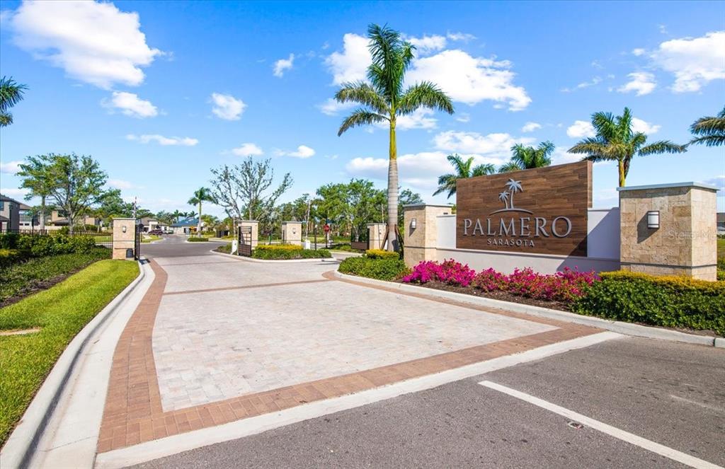 The entrance to the Palmero Sarasota community features a paved driveway and a wooden sign — 5756 HAVEN TERRACE, NOKOMIS, FL