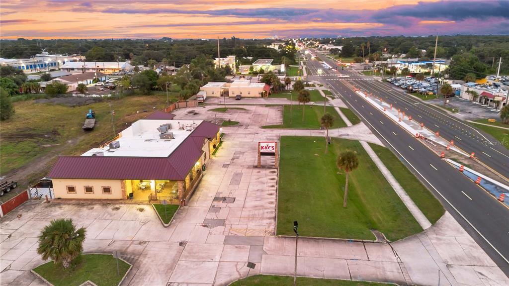 An aerial view shows a commercial building with a parking lot next to a road — 1552 W KING STREET, COCOA, FL