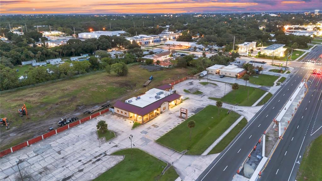 An aerial view shows a commercial building with a parking lot next to a highway — 1552 W KING STREET, COCOA, FL