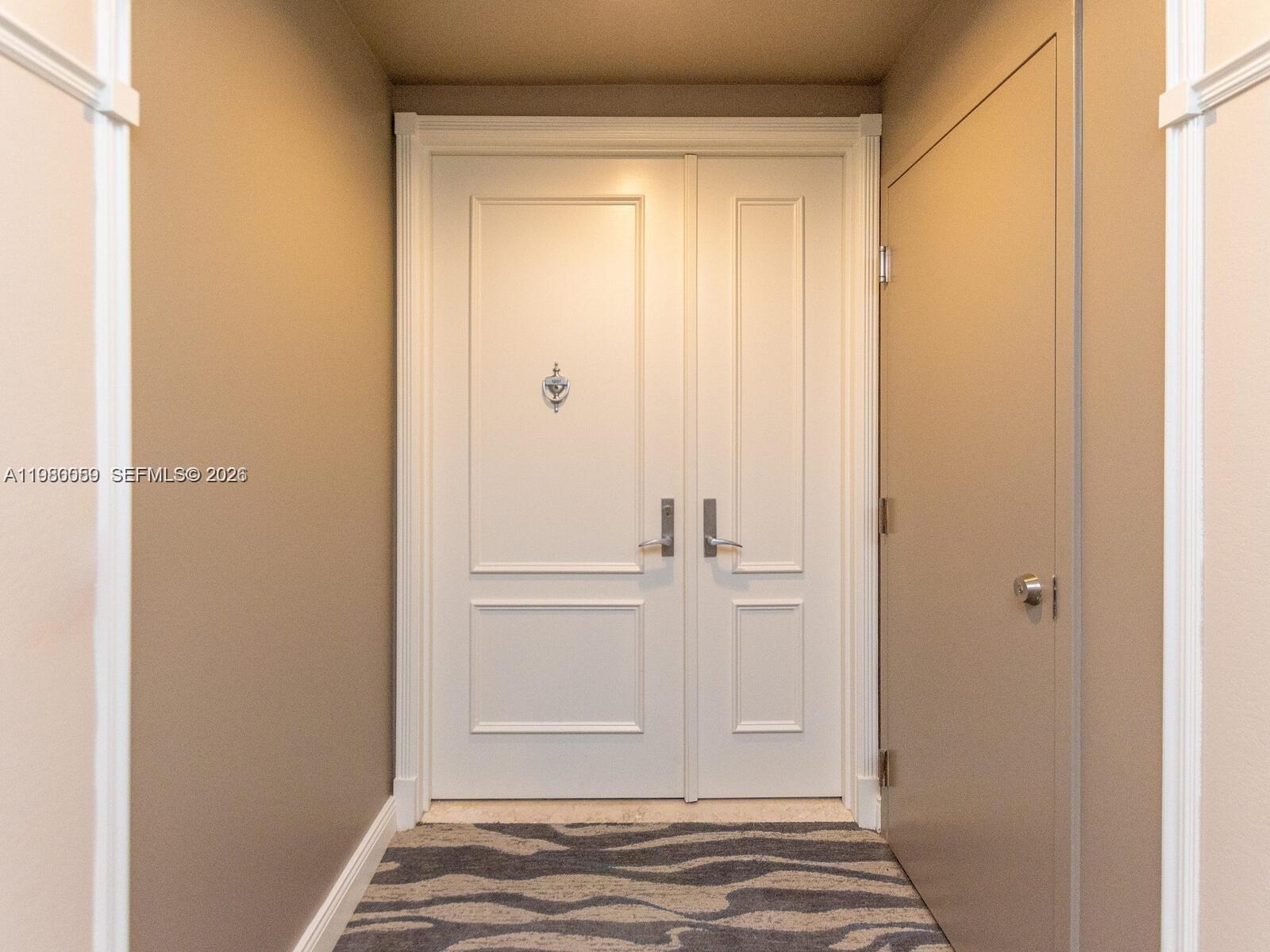 A hallway features a set of white double doors and a side door — 848 Brickell Key Dr # 1201, Miami FL 33131, MIAMI, FL