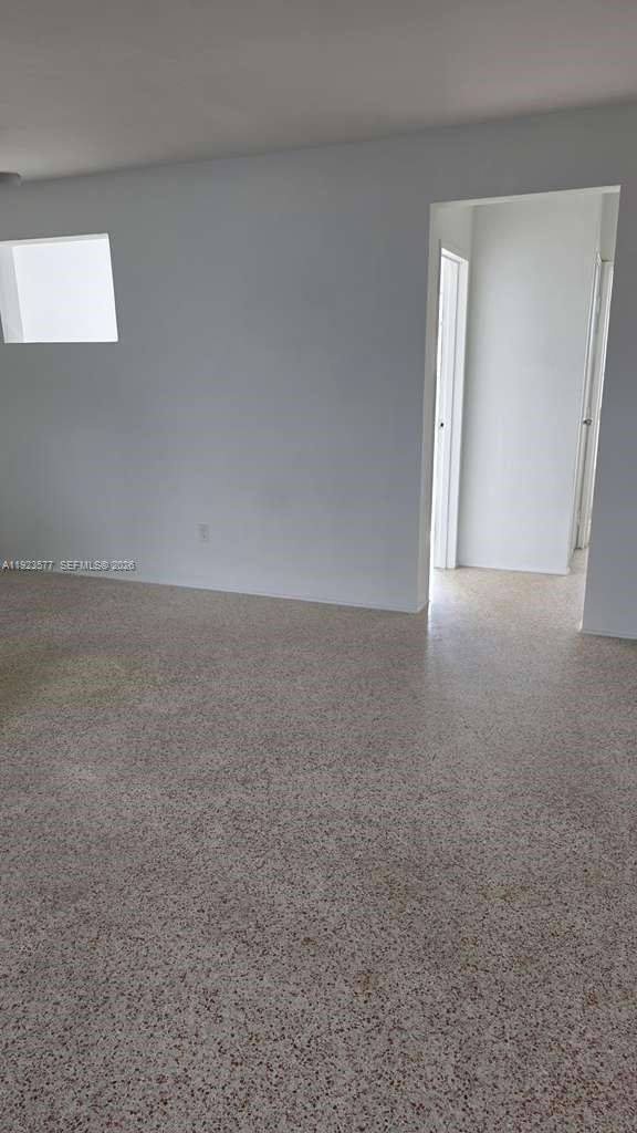 This bedroom features white walls, a ceiling fan, and speckled terrazzo flooring — 790 81st St, Miami Beach FL 33141, MIAMI BEACH, FL