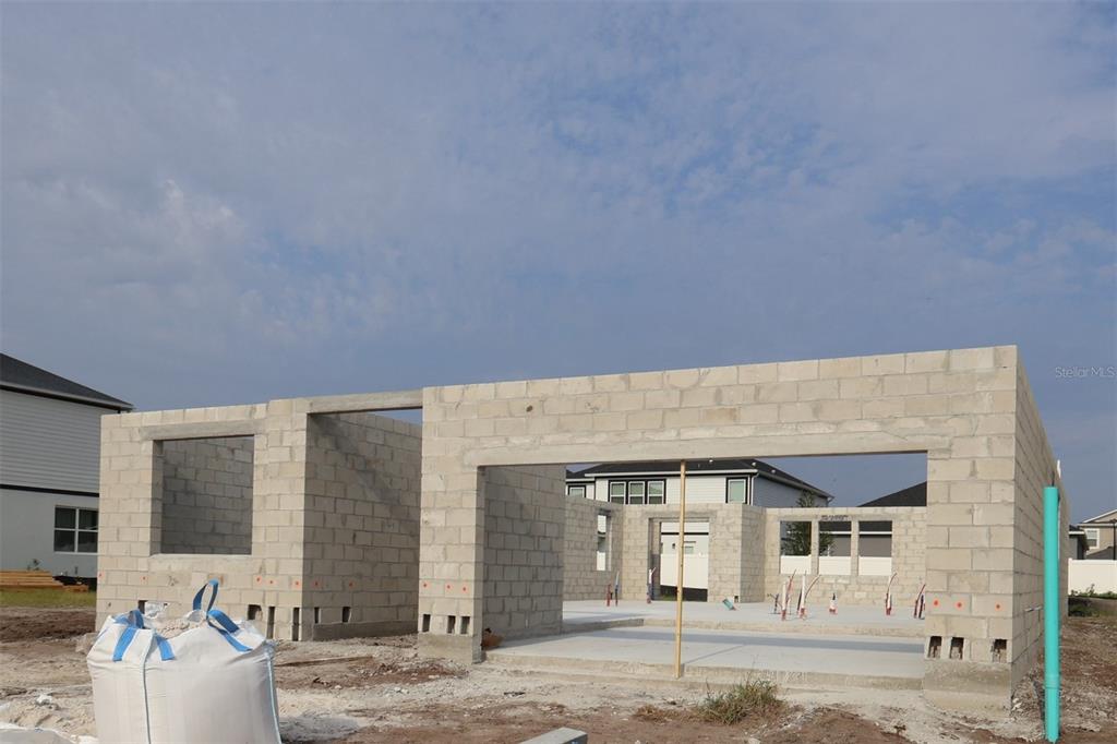 A construction site shows the concrete block walls of a house under development — 1164 BASALT LANE, SANFORD, FL
