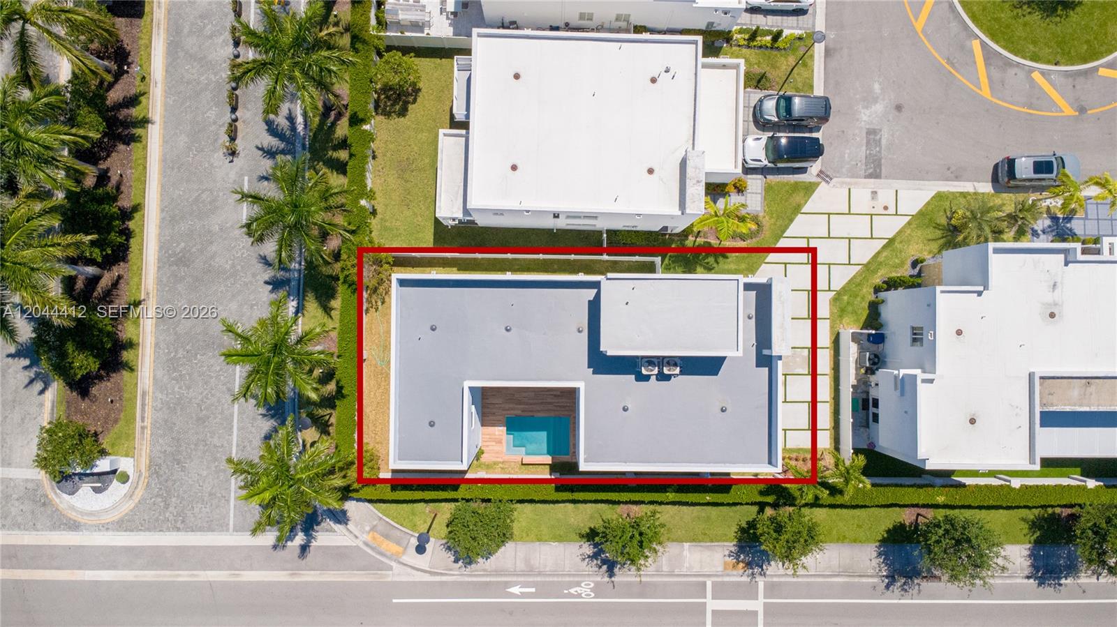 An aerial view shows a modern house with a flat roof and a small pool — 10381 NW 67th Ter, Doral FL 33178, DORAL, FL