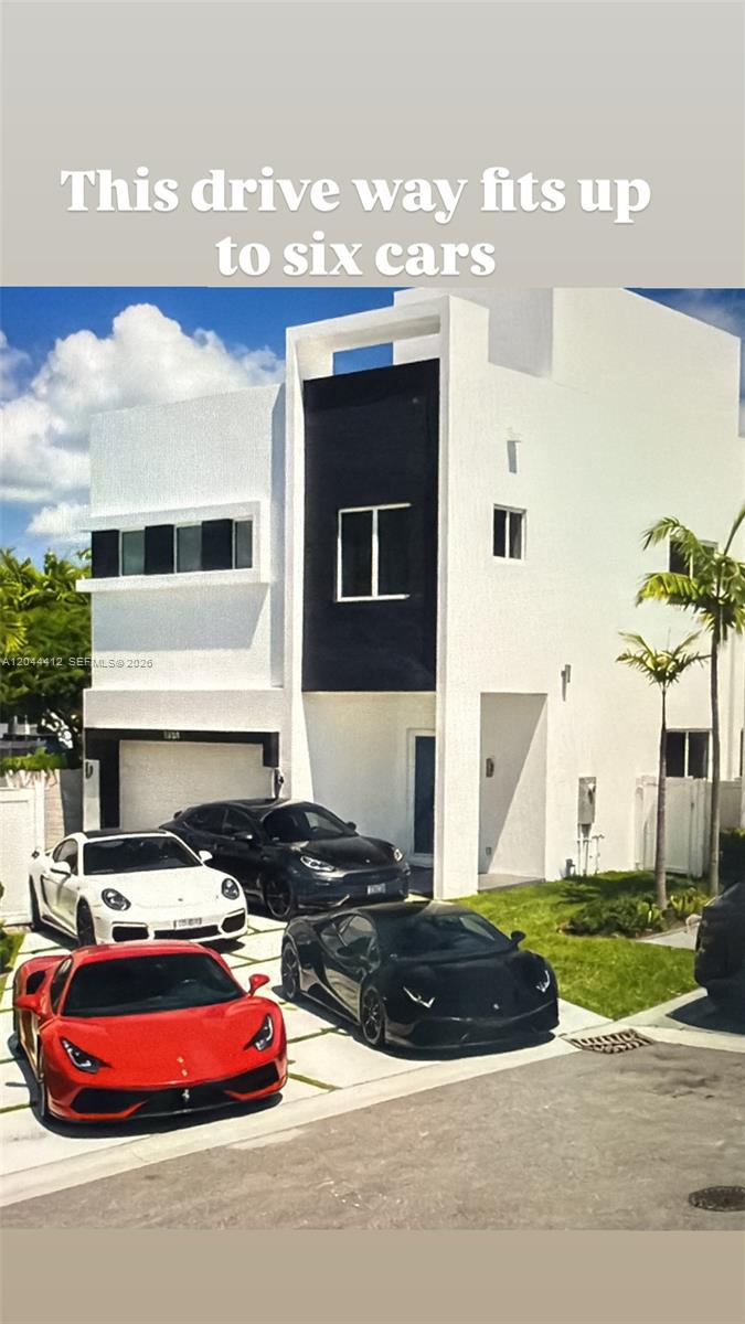 A modern white and black house features a paved driveway occupied by four luxury cars — 10381 NW 67th Ter, Doral FL 33178, DORAL, FL