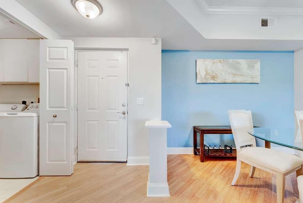 An entryway features a white door, light wood flooring, and a blue accent wall — 2417 Tuscany Way # 2417, Boynton Beach FL 33435, BOYNTON BEACH, FL