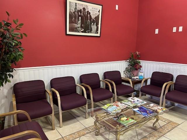 A waiting room features purple chairs, a glass coffee table, and a framed wall print — 6333 E STATE RD 54 ROAD E UNIT 6333, NEW PORT RICHEY, FL