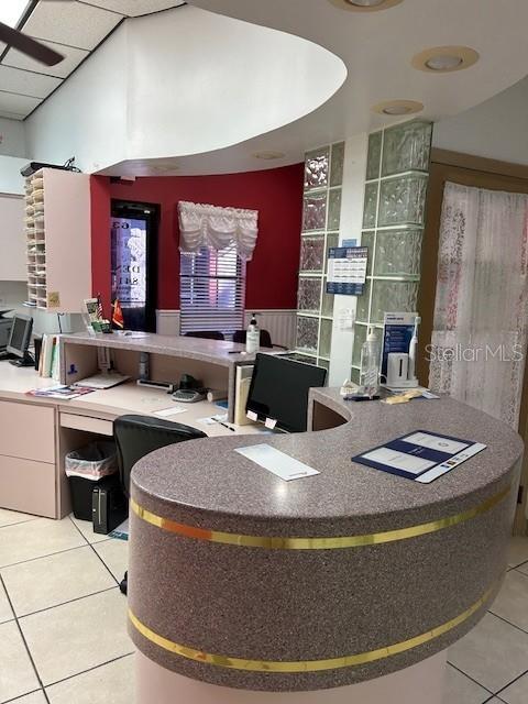 A reception area features a curved granite desk, glass block wall, and red accent wall — 6333 E STATE RD 54 ROAD E UNIT 6333, NEW PORT RICHEY, FL