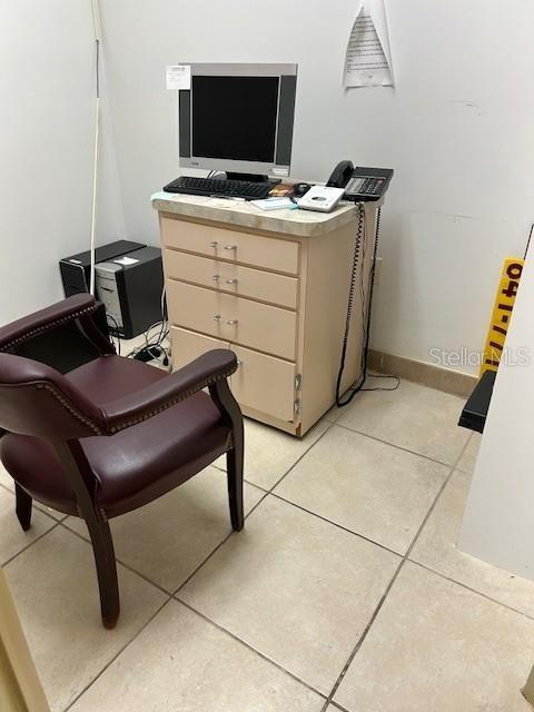 A small office space features a desk with a computer, a phone, and a chair — 6333 E STATE RD 54 ROAD E UNIT 6333, NEW PORT RICHEY, FL
