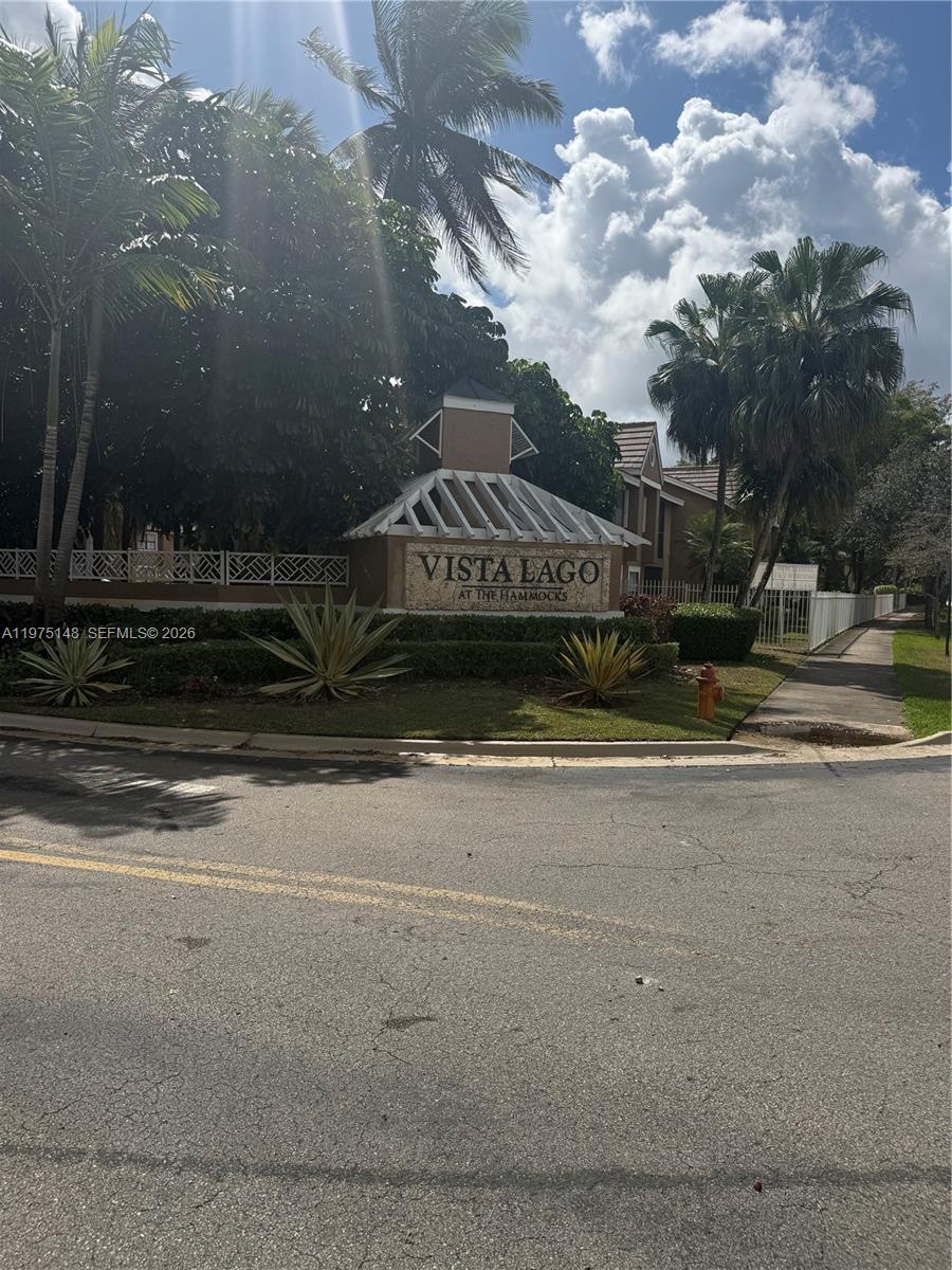 A sign for Vista Lago at The Hammocks stands near a sidewalk and palm trees — 15680 SW 106th LN # 803, Miami FL 33196, MIAMI, FL