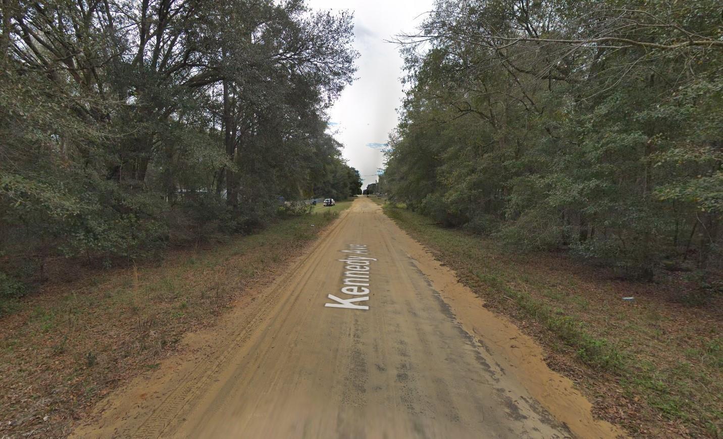 A dirt road named Kennedy Ave runs through a wooded area with trees on both sides — 622 Kennedy Avenue, FL 32148, FL