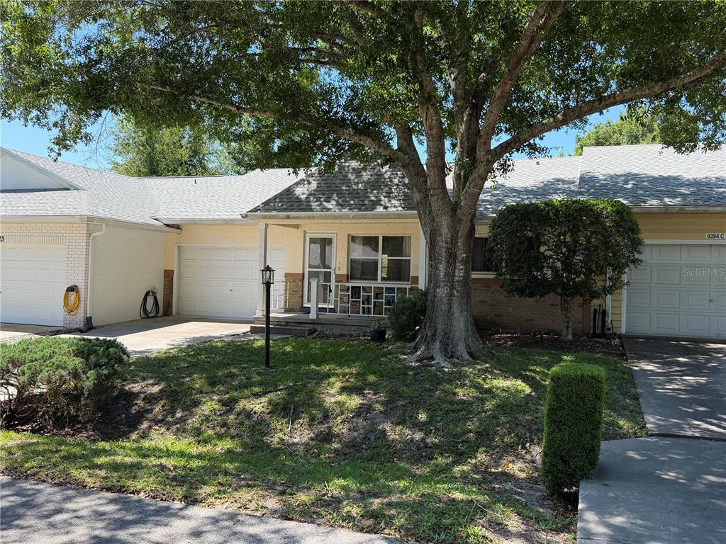 A single-story residential building with a large tree in the front yard — 9394 SW 97TH LANE UNIT B, OCALA, FL