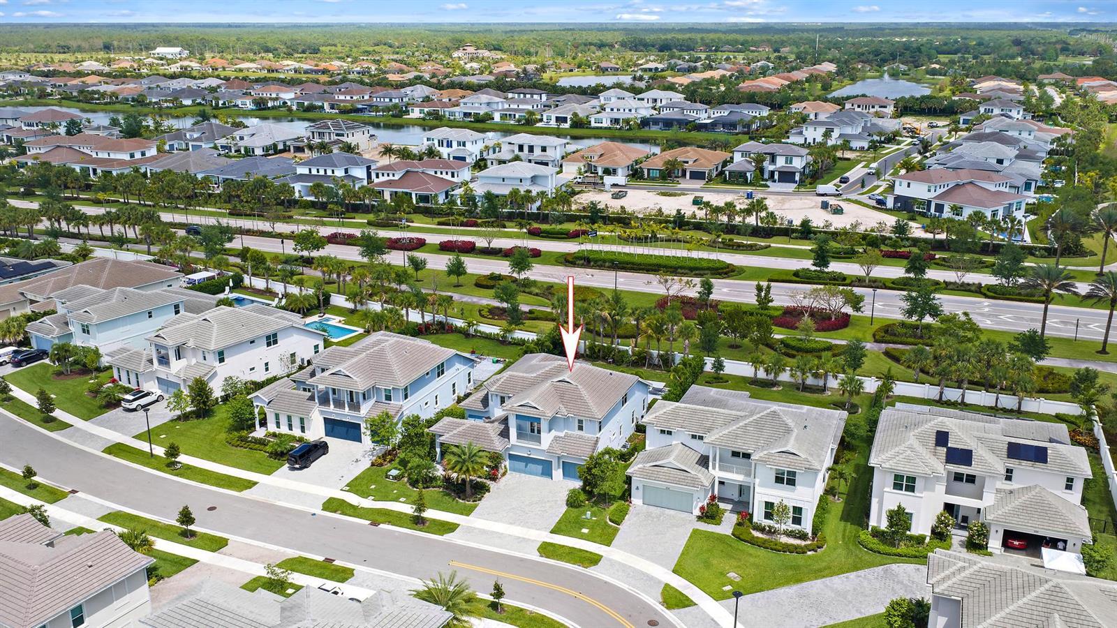 An aerial view shows a suburban neighborhood with a two-story house highlighted by an arrow — 9338 Crestview Circle, Palm Beach Gardens FL 33412, PALM BEACH GARDENS, FL