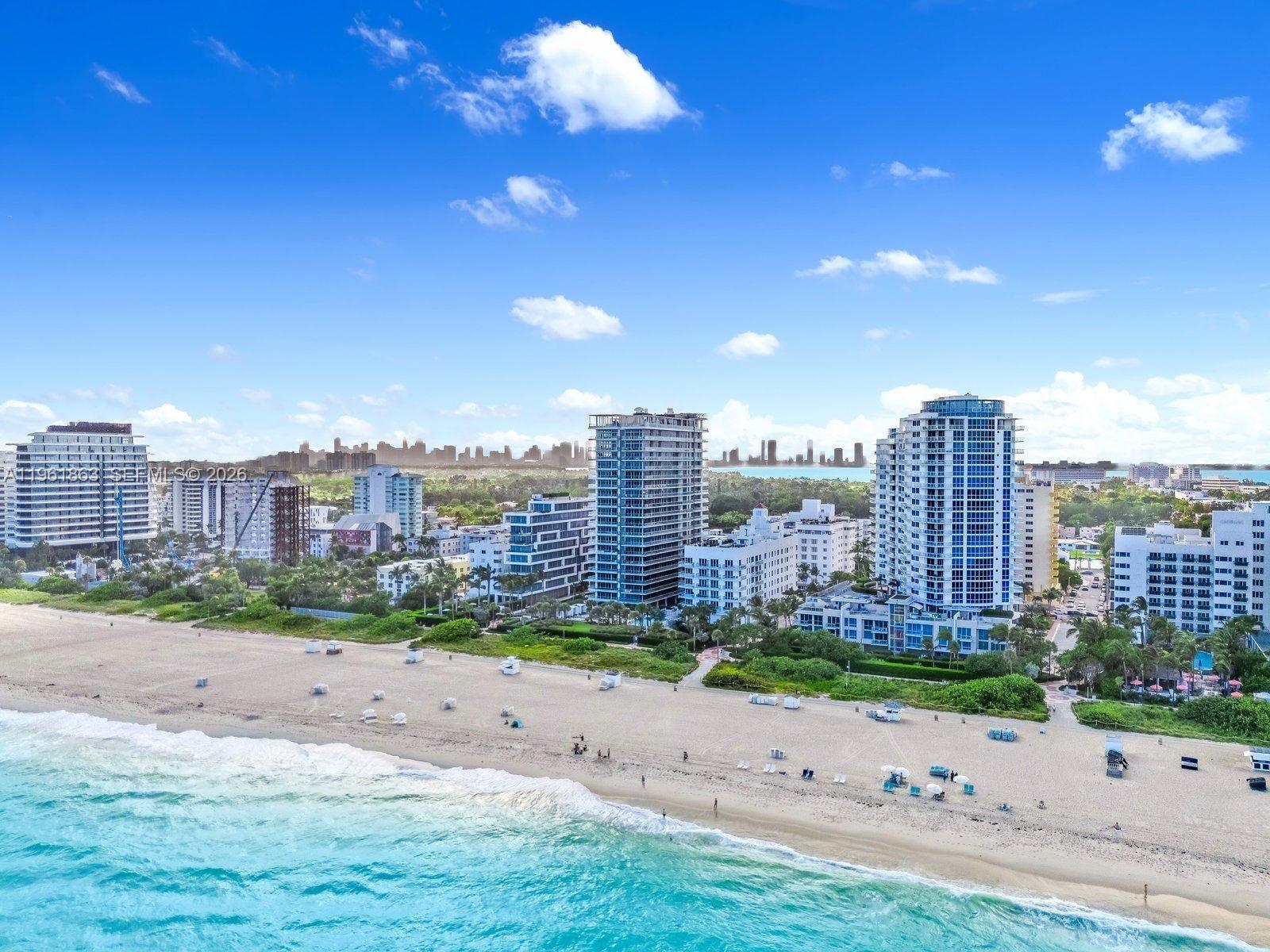 An aerial view of a sandy beach with high-rise buildings along the coastline — 3739 Collins Ave # 207, Miami Beach FL 33140, MIAMI BEACH, FL