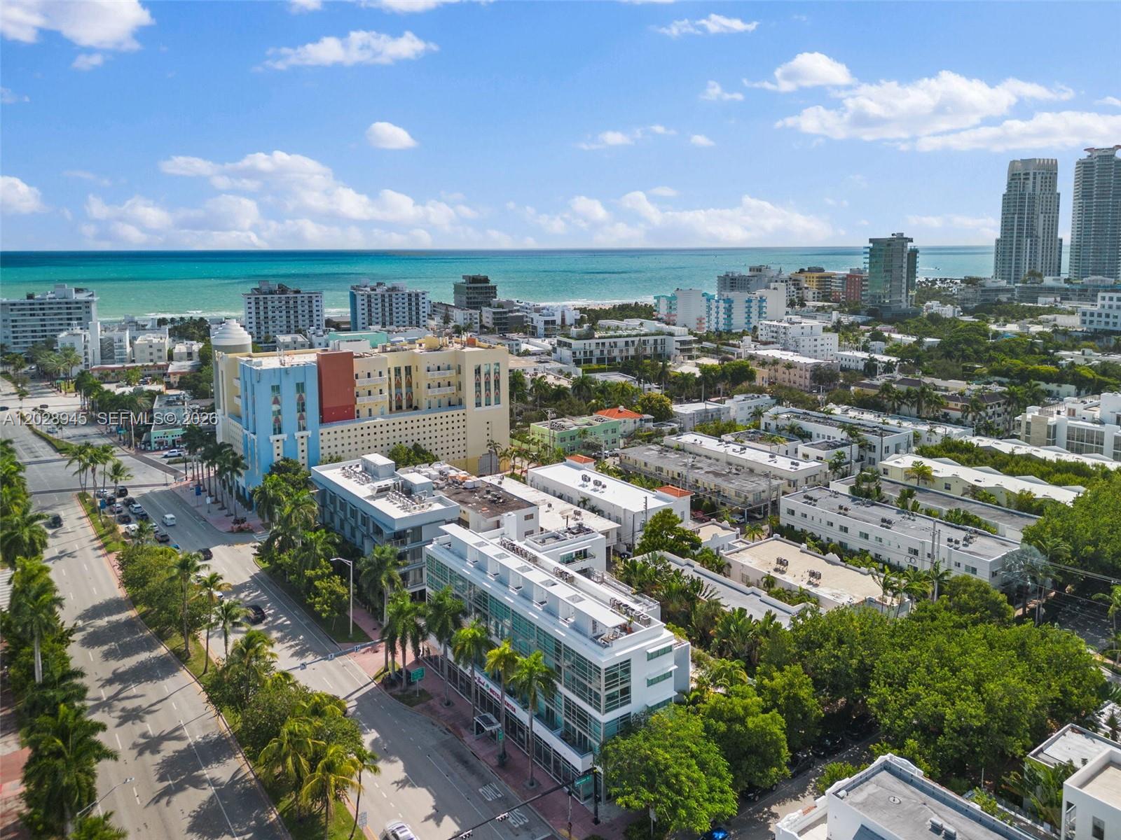 An aerial view shows a coastal city with multi-story buildings, palm trees, and the ocean — 421 Meridian Ave # 6, Miami Beach FL 33139, MIAMI BEACH, FL