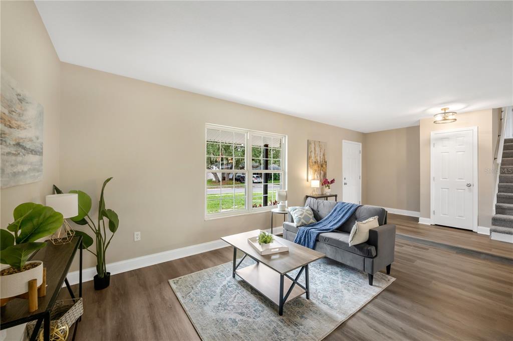 A rectangular swimming pool sits in a backyard with a patio, lawn, and large trees — 122 WINDY PLACE, BRANDON, FL