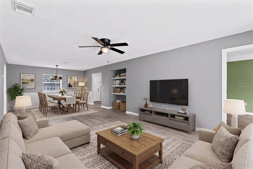 A living room and dining area with gray walls, wood-look flooring, and a ceiling fan — 4102 CLUBSIDE DRIVE, LONGWOOD, FL