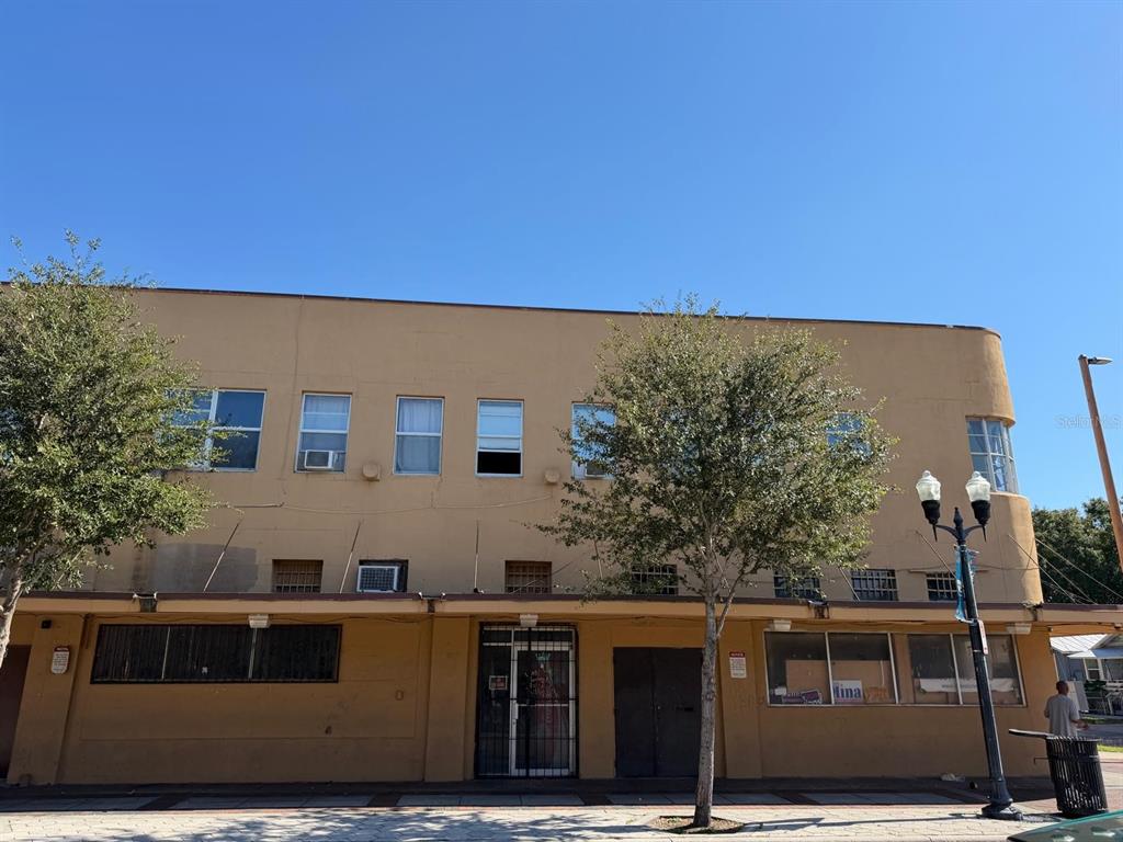 A tan, two-story commercial building with a flat roof and ground-level storefront windows — 221 S PARRAMORE AVENUE UNIT 7A, ORLANDO, FL