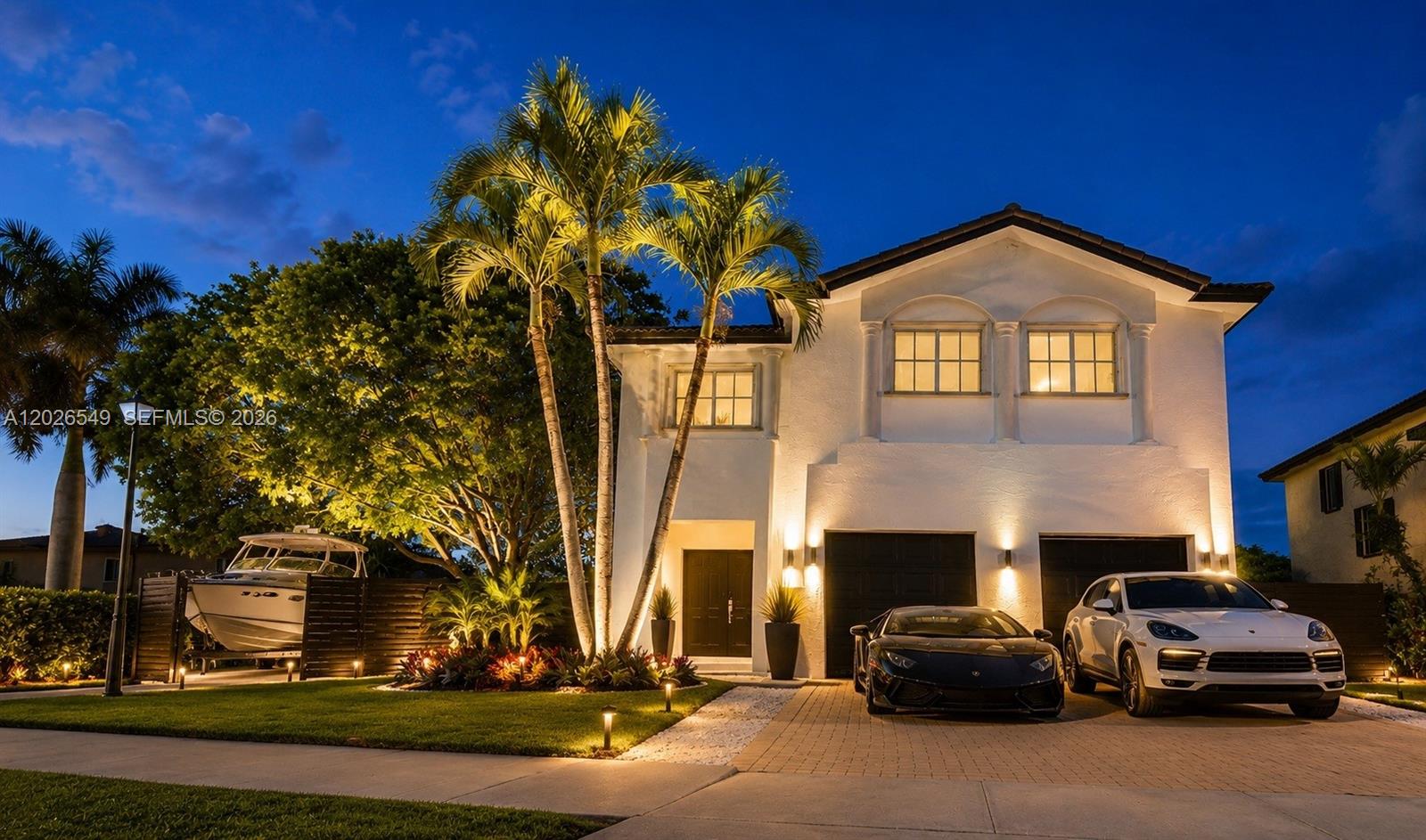 A two-story white house at dusk with a boat, two cars, and palm trees — 14407 SW 158th Path, Miami FL 33196, MIAMI, FL