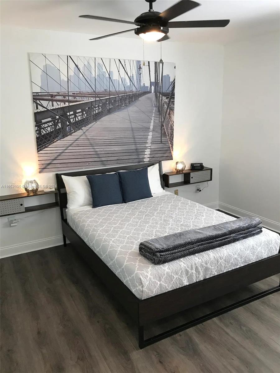 A bedroom features a platform bed, floating nightstands, and a large Brooklyn Bridge wall mural — 2615 Collins Ave # 24, Miami Beach FL 33140, MIAMI BEACH, FL