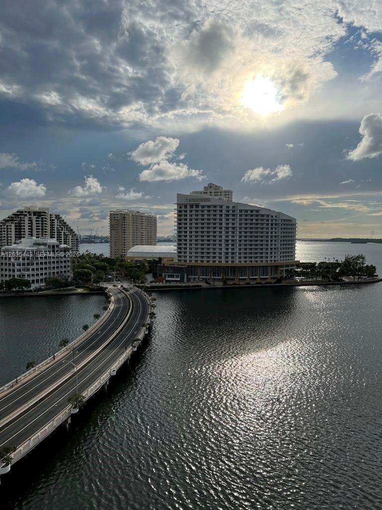 An elevated view shows a curved bridge leading to a large waterfront hotel complex — 801 Brickell Bay Dr # 1469, Miami FL 33131, MIAMI, FL