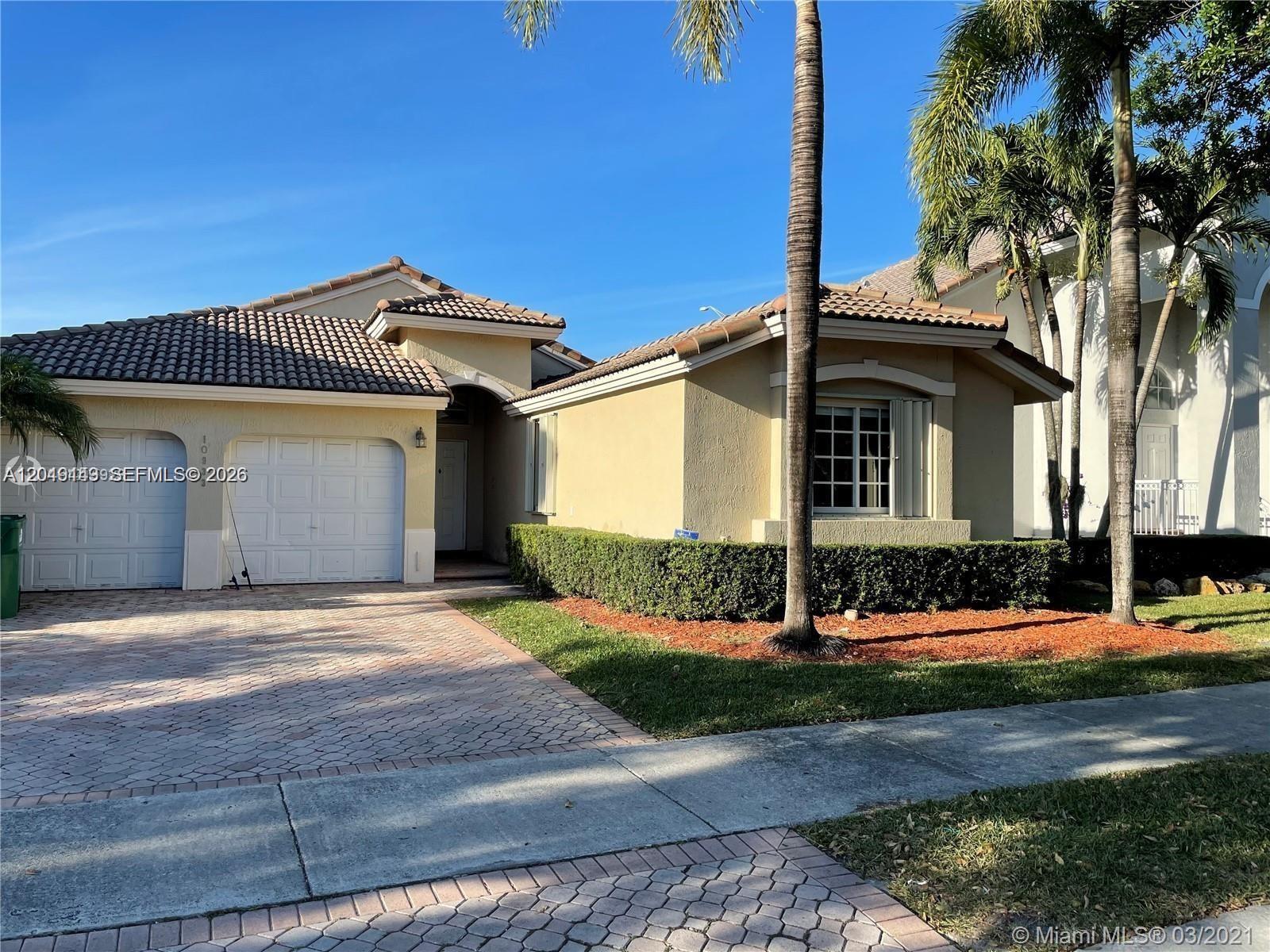 A single-story house with a tiled roof, a two-car garage, and a landscaped front yard — 10933 NW 73 TE, Doral FL 33178, DORAL, FL