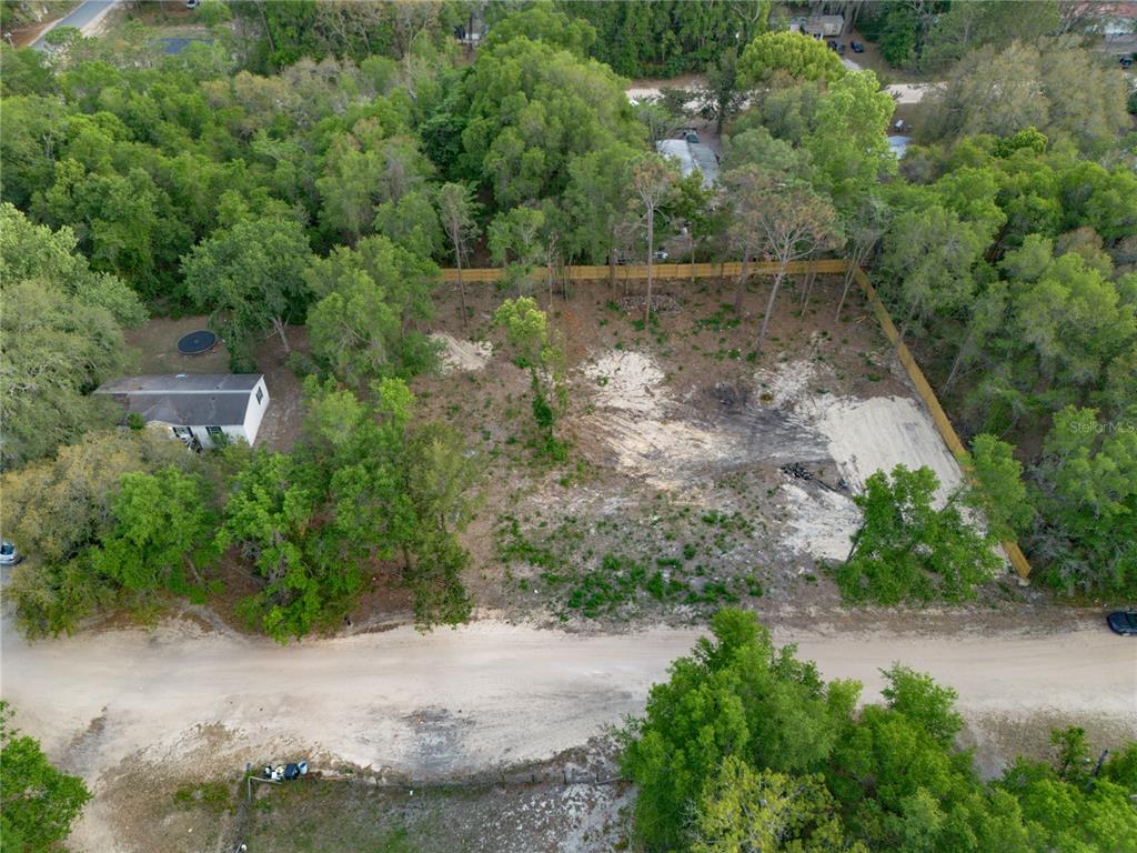 An aerial view shows a cleared, fenced residential lot next to a small house — 6397 BAYLOR AVENUE, KEYSTONE HEIGHTS, FL
