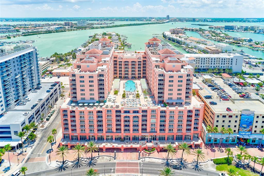 A rooftop terrace features a small pool, lounge chairs, and pergolas overlooking the ocean — 301 S GULFVIEW BOULEVARD UNIT 301, CLEARWATER BEACH, FL