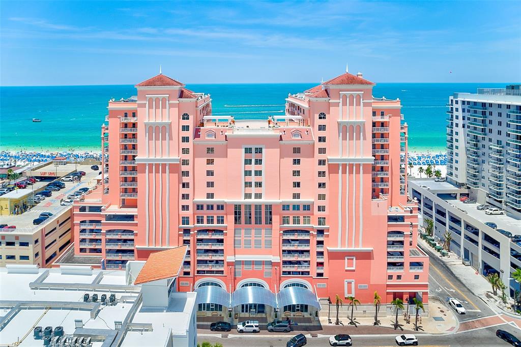 A hallway features a white door, an elevator with a number three, and tile flooring — 301 S GULFVIEW BOULEVARD UNIT 301, CLEARWATER BEACH, FL