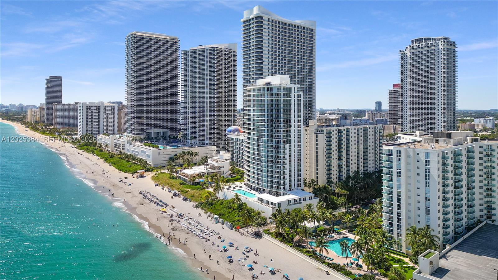 An aerial view shows high-rise residential buildings along a sandy beach and the ocean — 4001 S Ocean Dr # 3P, Hollywood FL 33019, HOLLYWOOD, FL