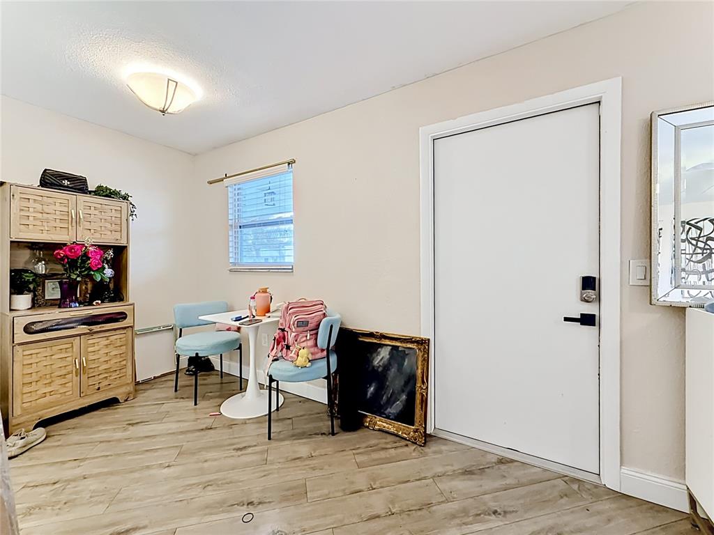 A small dining area features a white table, two blue chairs, and a wooden hutch — 4050 4TH STREET N UNIT 304, ST PETERSBURG, FL
