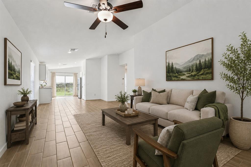 A living room features a beige sofa, green armchair, wood coffee table, and tile flooring — 11290 LIBERTO ROAD, WEEKI WACHEE, FL