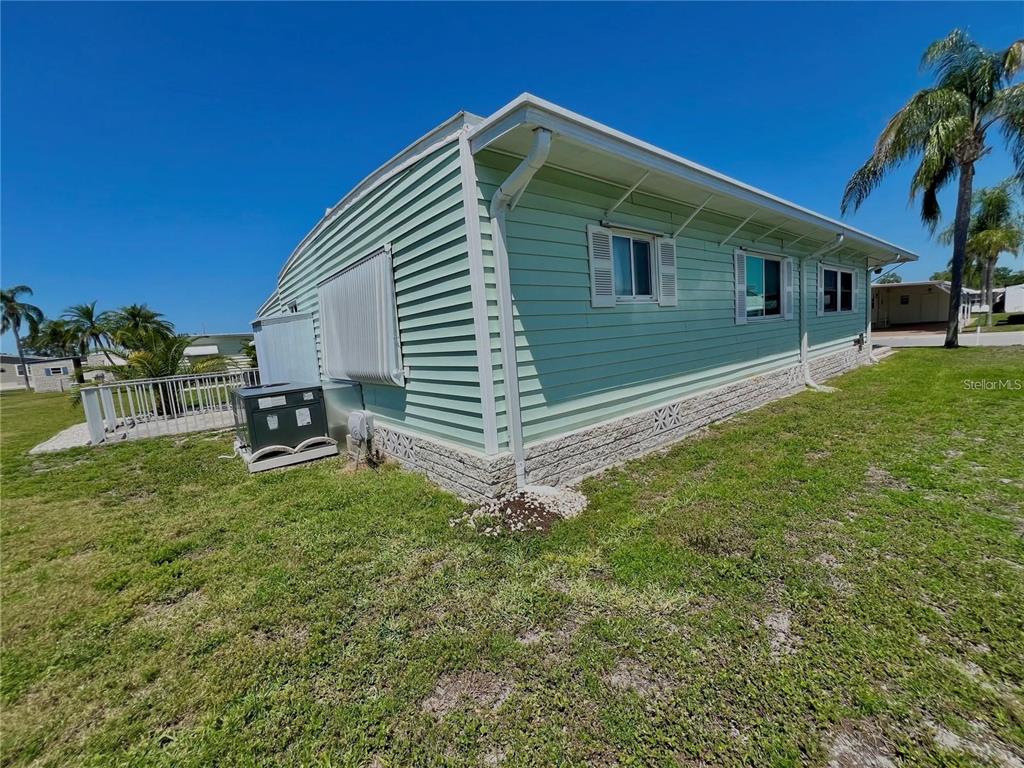 The exterior of a light green mobile home with a concrete block foundation — 1100 BELCHER ROAD S UNIT 772, LARGO, FL