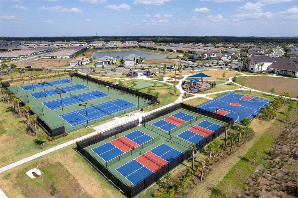 An aerial view shows tennis courts, a basketball court, a playground, and a residential neighborhood — 14275 PINE LODGE LANE, FORT MYERS, FL