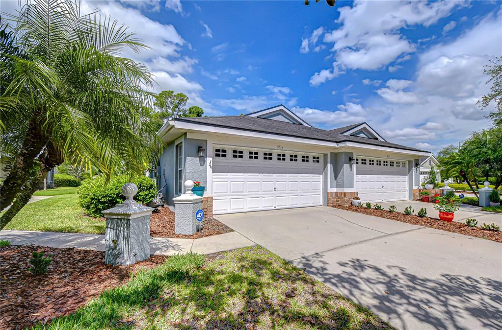 A dining area with a wooden table, white chairs, and a large antique-style display cabinet — 9815 GINGERWOOD DRIVE, TAMPA, FL