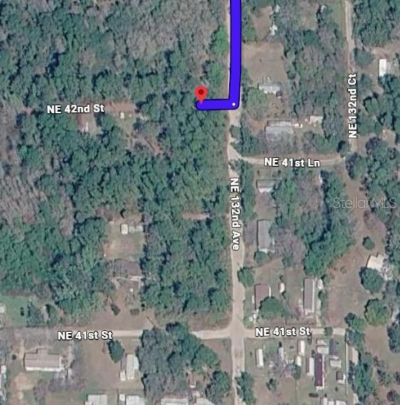 This is an aerial map view showing a wooded lot and surrounding residential streets — NE 41ST PLACE, SILVER SPRINGS, FL