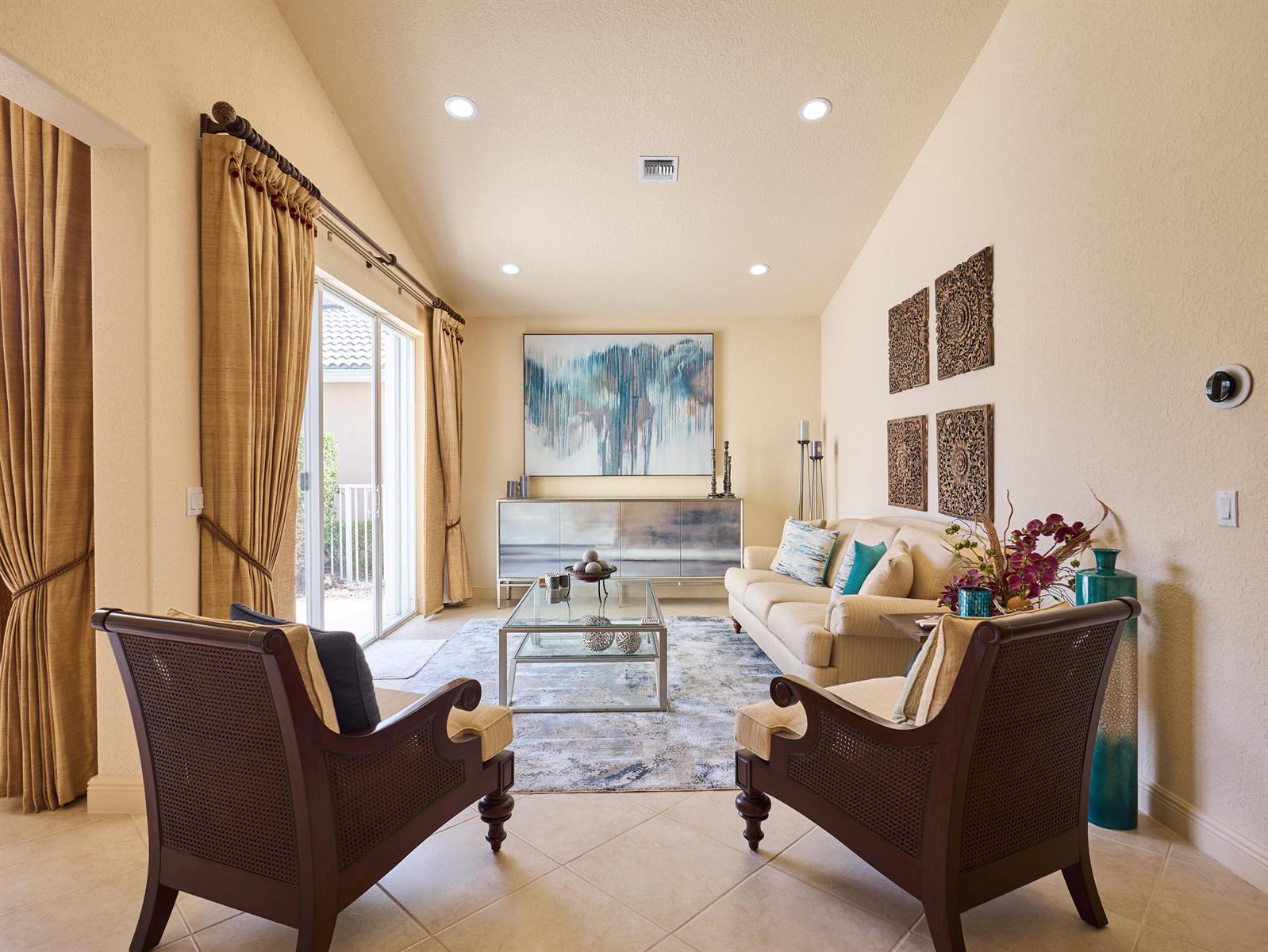 A living room features two dark wood chairs, a beige sofa, and a glass coffee table — 8282 Spyglass Drive, West Palm Beach FL 33412, WEST PALM BEACH, FL