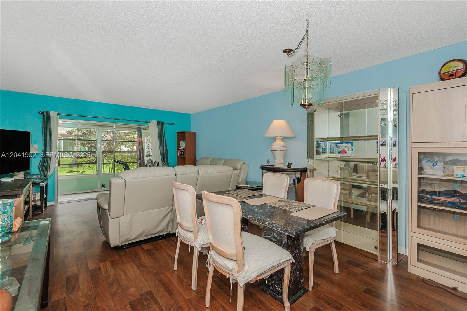A dining area with a marble table and chairs sits next to a living room — 7200 NW 4th Pl # 101, Margate FL 33063, MARGATE, FL