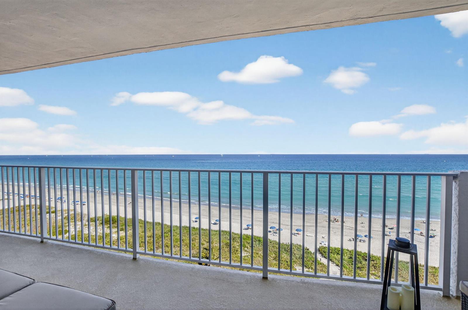 A balcony with a metal railing overlooks a sandy beach and the ocean — 3000 S Ocean Boulevard # 1004, Boca Raton FL 33432, BOCA RATON, FL