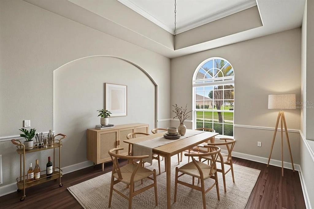 A home office features built-in white shelving, a desk, a rolling chair, and wood-look flooring — 200 LAKE ARIETTA COURT, AUBURNDALE, FL