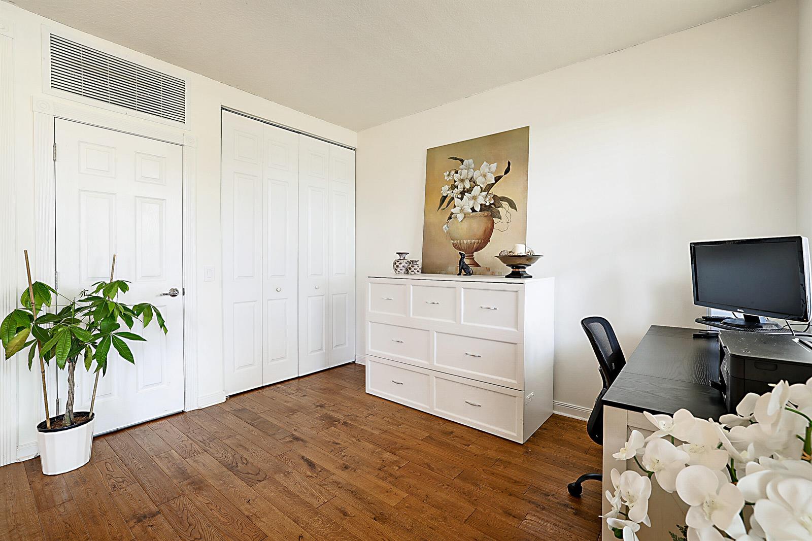 A home office with white walls, wood flooring, a white dresser, and a desk — 3414 W Mallory Boulevard, Jupiter FL 33458, JUPITER, FL