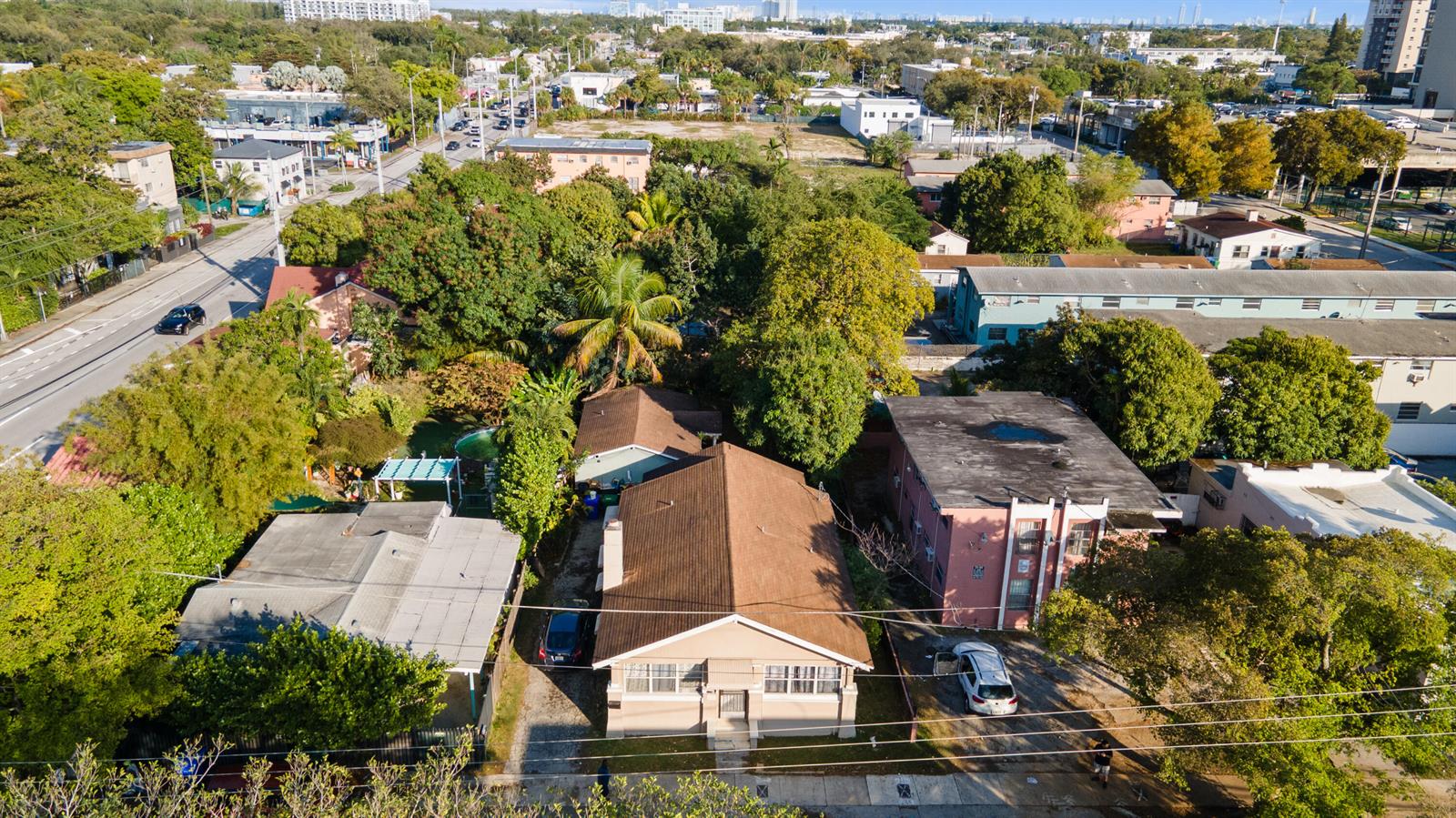 An aerial view shows a residential street with houses, trees, and parked vehicles — 8111 NE 1st Avenue, Miami FL 33138, MIAMI, FL