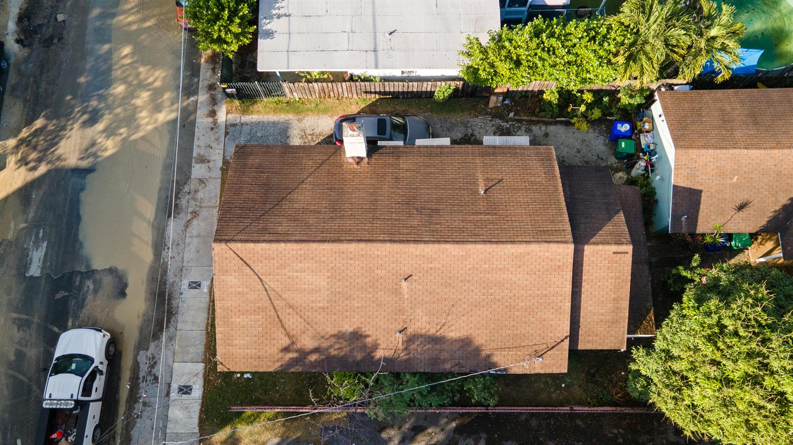 An aerial view shows a brown shingled roof of a house with a chimney — 8111 NE 1st Avenue, Miami FL 33138, MIAMI, FL