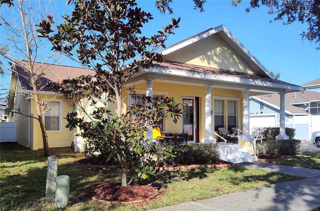 A yellow one-story house with a front porch, white columns, and a small front yard — 3639 HURSTON STREET, NEW PORT RICHEY, FL