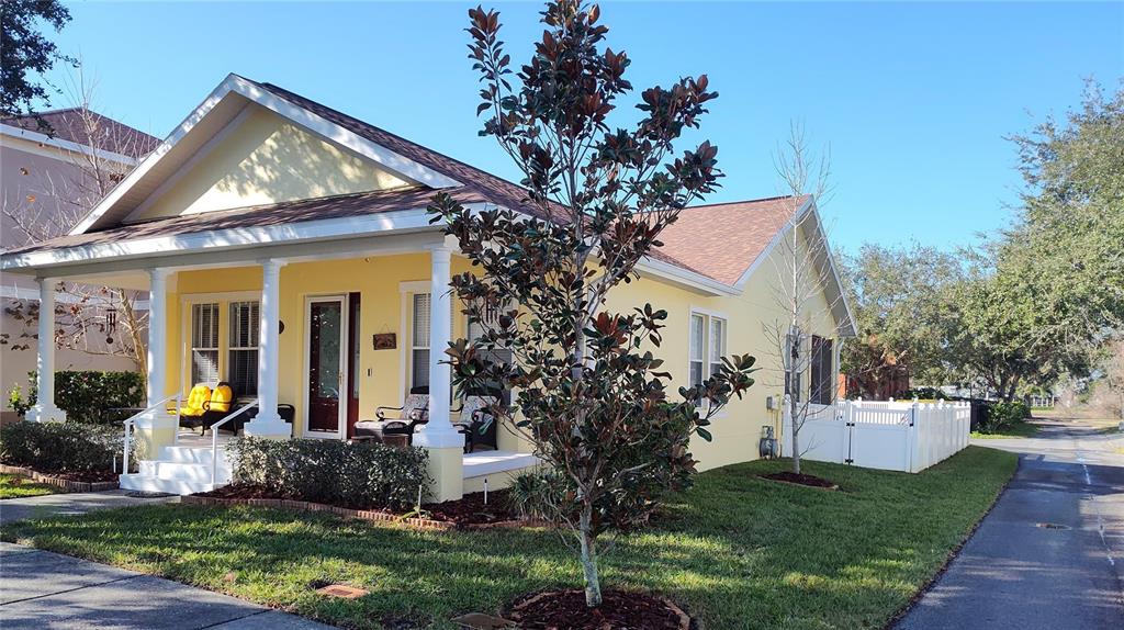 A yellow single-story house with a front porch, white columns, and a white fence — 3639 HURSTON STREET, NEW PORT RICHEY, FL