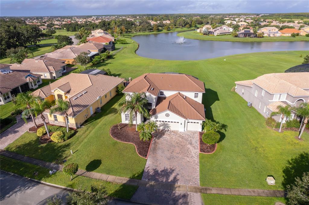 An aerial view shows a suburban house with a tiled roof and a paved driveway — 3426 HARBORSIDE COURT, KISSIMMEE, FL