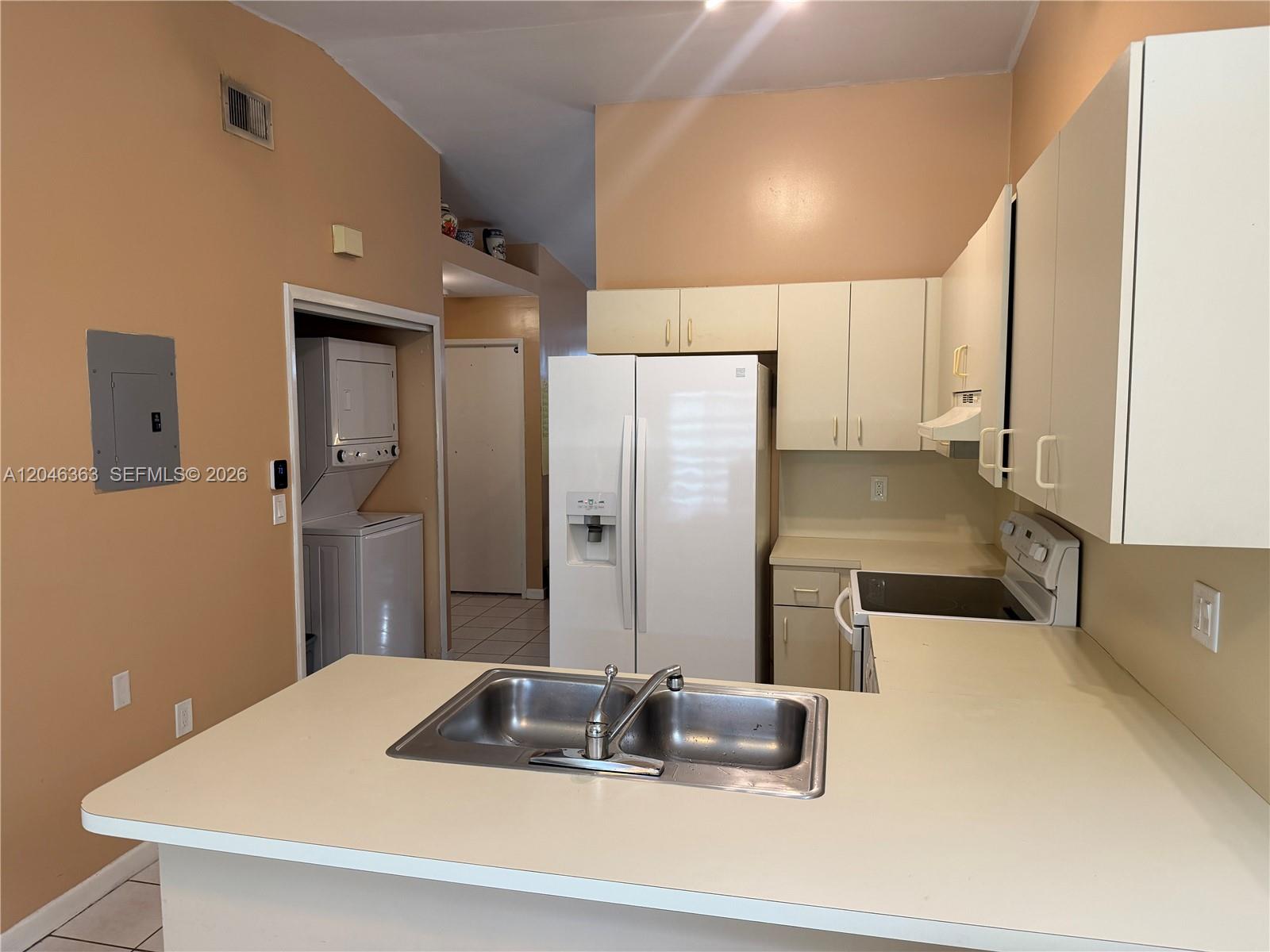 A kitchen features white appliances, light-colored cabinets, and a stainless steel double-basin sink — 6718 NW 166th Ter # 301, Miami Lakes FL 33014, MIAMI LAKES, FL