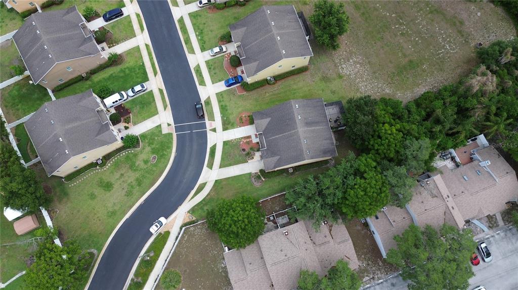 An aerial view shows several suburban houses with driveways, lawns, and a curved residential street — 1111 PETERSON PLACE, SANFORD, FL